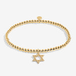 Gold beaded bracelet with a Star of David charm on a white background. Available at Be Charmed