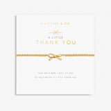 A gold-tone bracelet with a bow-shaped charm, presented on a card with the text 'A Littles & Co. A Little THANK YOU'. Available at Be Charmed