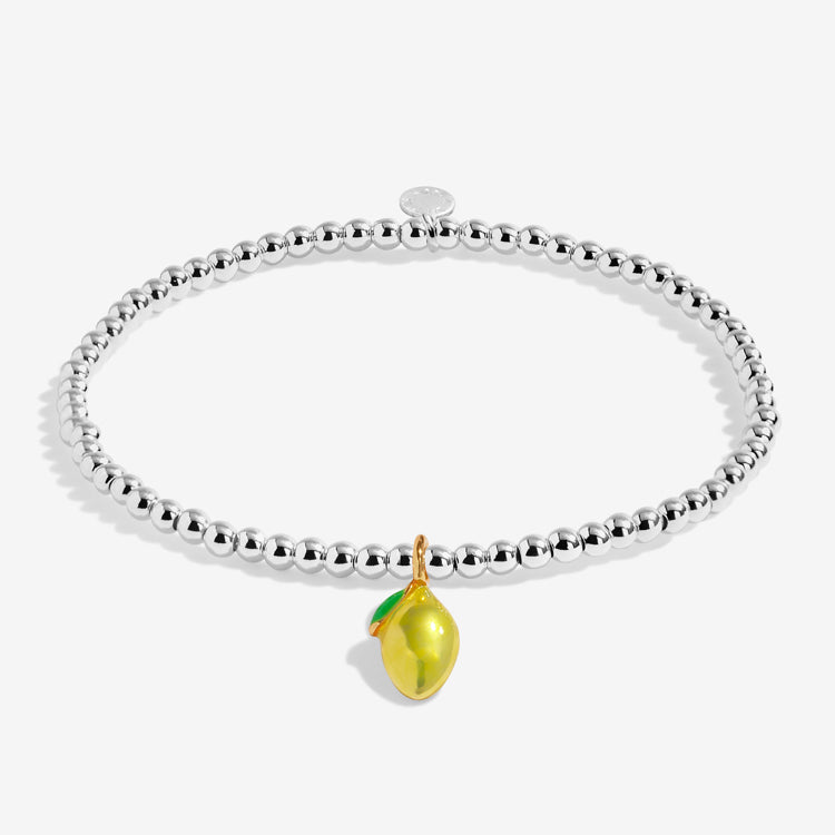 A Littles Company Silver bracelet with a yellow lemon charm on a white background.  Available at Be Charmed