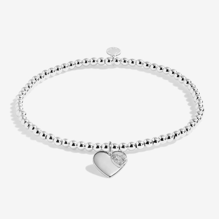A littles & Co Silver bracelet with a heart-shaped charm on a white background. Available at Be Charmed