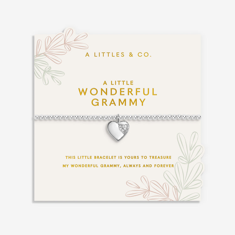 A Little & Co Silver bracelet with heart charm on a white card with text and branding. Available at Be Charmed