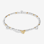 Bracelet with heart-shaped charms on a white background. Available at Be Charmed