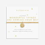 Gold bracelet with a circular charm on a white card with text, featuring 'A Littles & Co.' brand. Available at Be Charmed