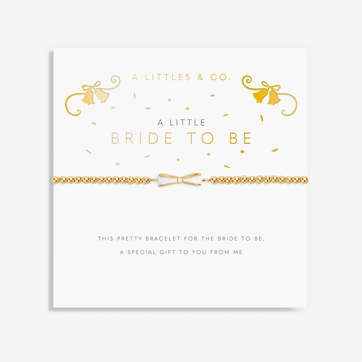 A gold-colored bracelet labeled 'A Littles & Co. Bride To Be' with a pretty bow charm, presented on a white card with gold accents and text.