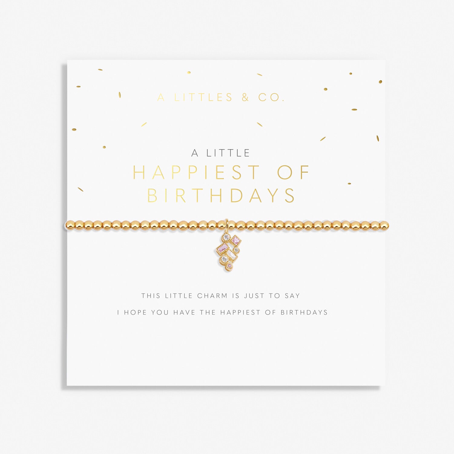 A gold-tone plated bracelet with the inscription 'Happiest of Birthdays' on a greeting card presentation. Available at Be Charmed