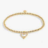 A Littles & Co Gold Happy Birthday Mom Bracelet featuring a delicate gold-plated heart charm on a stretch bead band, a sentimental gift for moms, available at Be Charmed