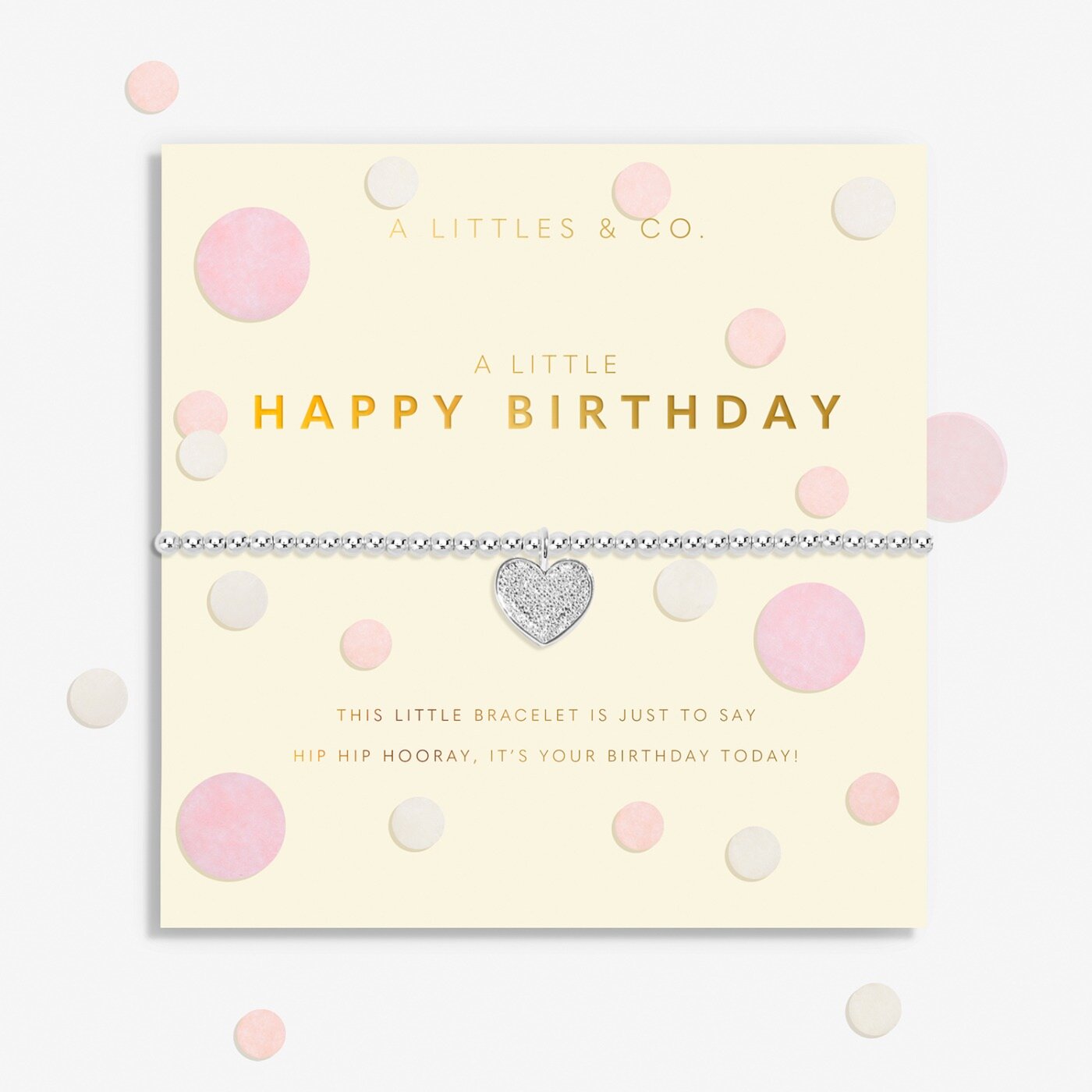 Bracelet with heart charm on a 'Happy Birthday' card with polka dots. Available at Be Charmed.  