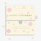 Bracelet with heart charm on a 'Happy Birthday' card with polka dots. Available at Be Charmed.  