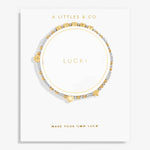 Bracelet with gold and silver beads on a white card with 'A Littles & Co.' branding. Available at Be Charmed