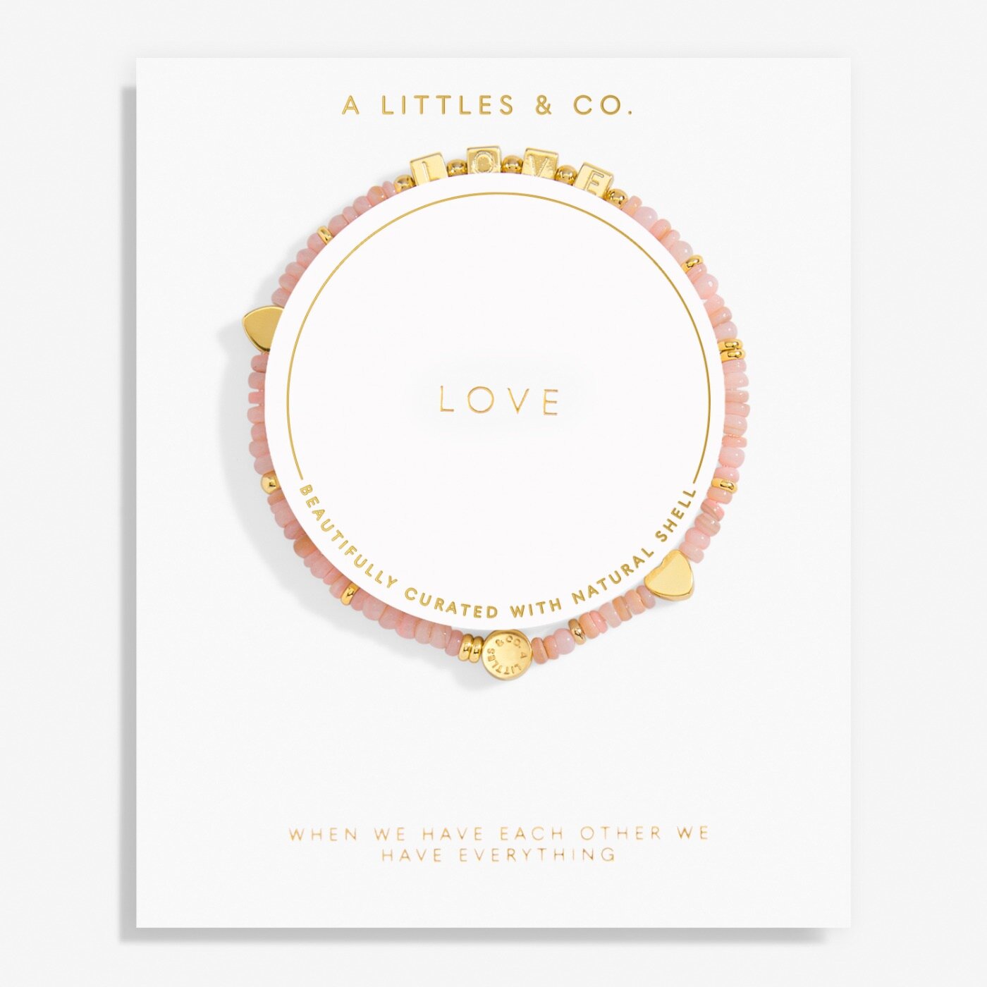 Pink beaded bracelet with gold accents on a white card with 'A Littles & Co.' branding. Available at Be Charmed