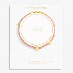 Pink beaded bracelet with gold accents on a white card with 'A Littles & Co.' branding. Available at Be Charmed