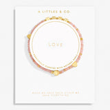 Pink beaded bracelet with gold accents on a white card with 'A Littles & Co.' branding. Available at Be Charmed
