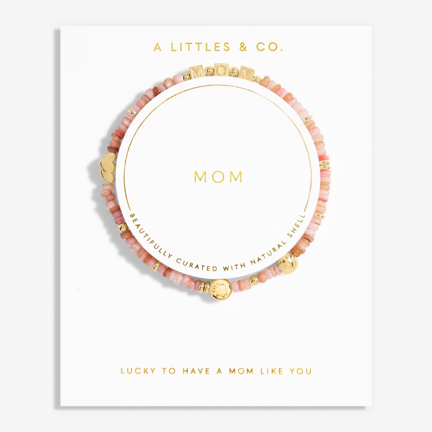 Bracelet with 'Mom' engraving on a white card with 'A Littles & Co.' branding. Available at Be Charmed