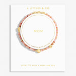 Bracelet with 'Mom' engraving on a white card with 'A Littles & Co.' branding. Available at Be Charmed