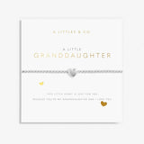 A Littles & Co Granddaughter Silver Bracelet featuring a dainty silver-plated heart charm on a stretch bead band, displayed on a loving sentiment card, a treasured gift for granddaughters, available at Be Charmed