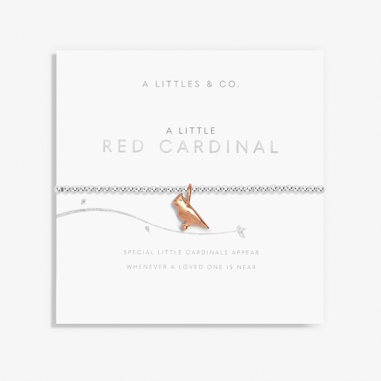 A Littles & Co Red Cardinal Silver Bracelet featuring a silver-plated stretch band with a detailed red cardinal charm, displayed on a loving message card symbolizing remembrance and comfort, a meaningful gift available at Be Charmed