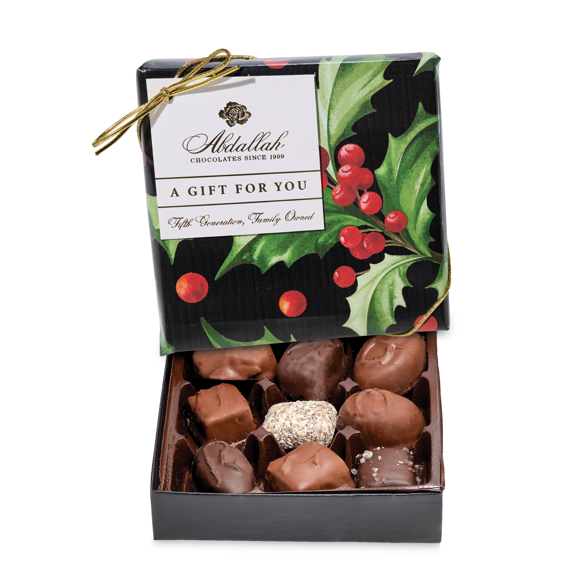Box of chocolates with a decorative lid featuring holly design and Abdallah Chocolates branding. Available at Be Charmed. 
