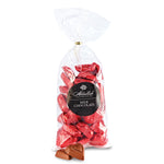 Bag of red milk chocolate candies with a Abdallah  brand label on a white background. Available at Be Charmed