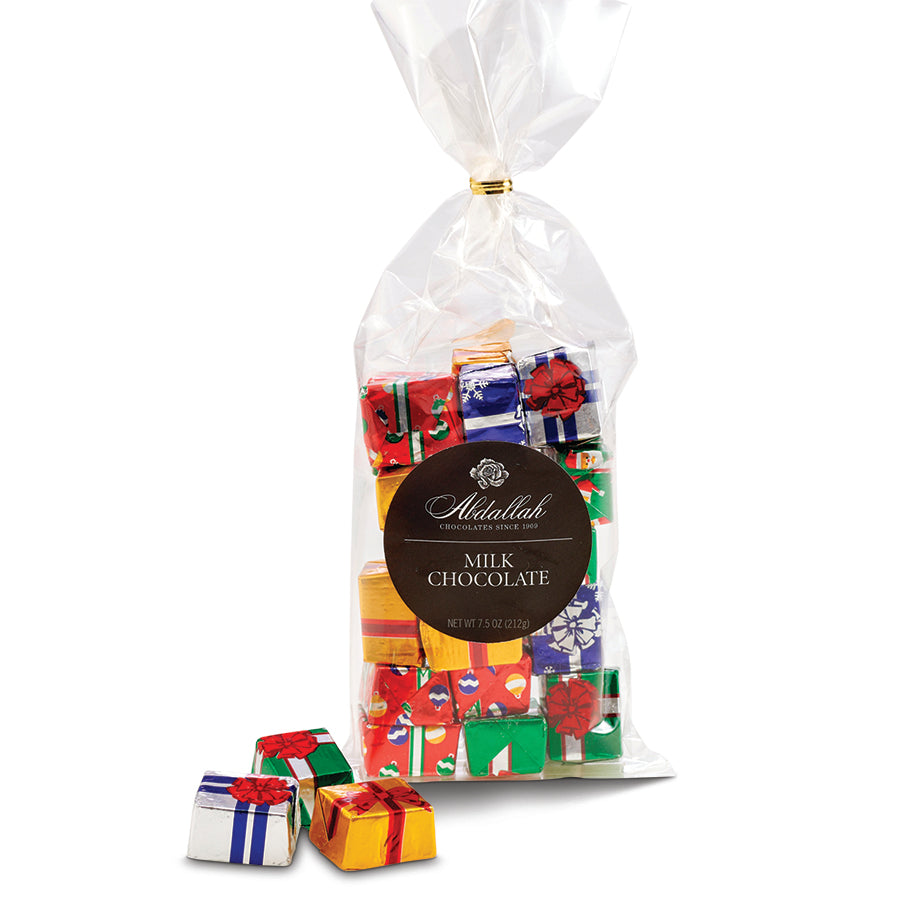 Bag of milk chocolates with colorful gift wrappers and Abdallah branding on a white background. Available at Be Charmed. 
