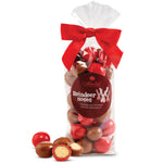 Bag of Abdallah chocolate-covered treats labeled 'Reindeer noses' with a red bow on a white background. Available at Be Charmed. 