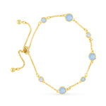 Gold bracelet with light blue gemstones on a white background. Available at Be Charmed