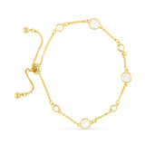 Gold bracelet with pearl-like beads on a white background. Available at Be Charmed