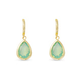 Gold earrings with green teardrop-shaped gemstones on a white background. Available at Be Charmed