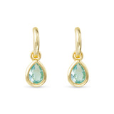Gold earrings with green teardrop stones on a white background. Available at Be Charmed