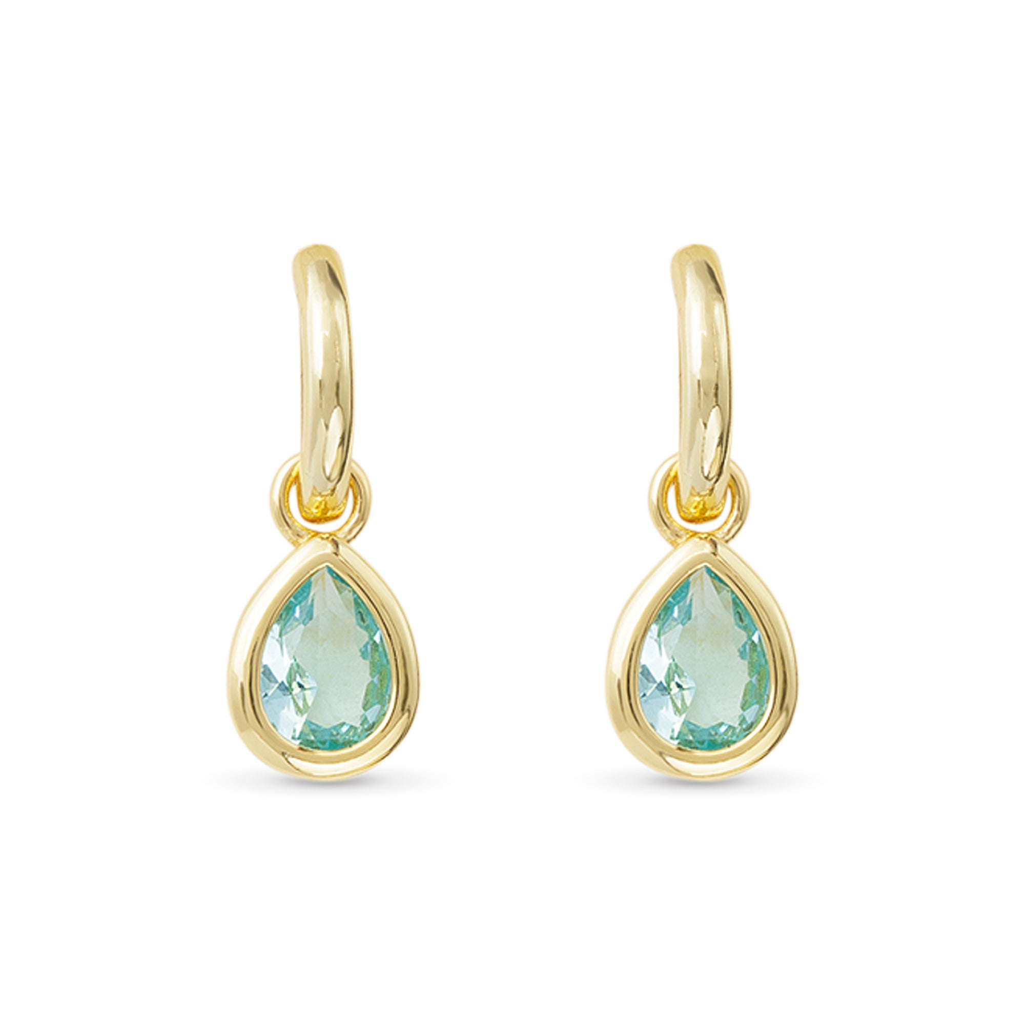Gold earrings with green teardrop stones on a white background. Available at Be Charmed