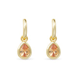 Gold earrings with teardrop-shaped topaz gemstones on a white background. Available at Be Charmed