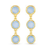 Gold earrings with blue gemstones on a white background. Available at Be Charmed