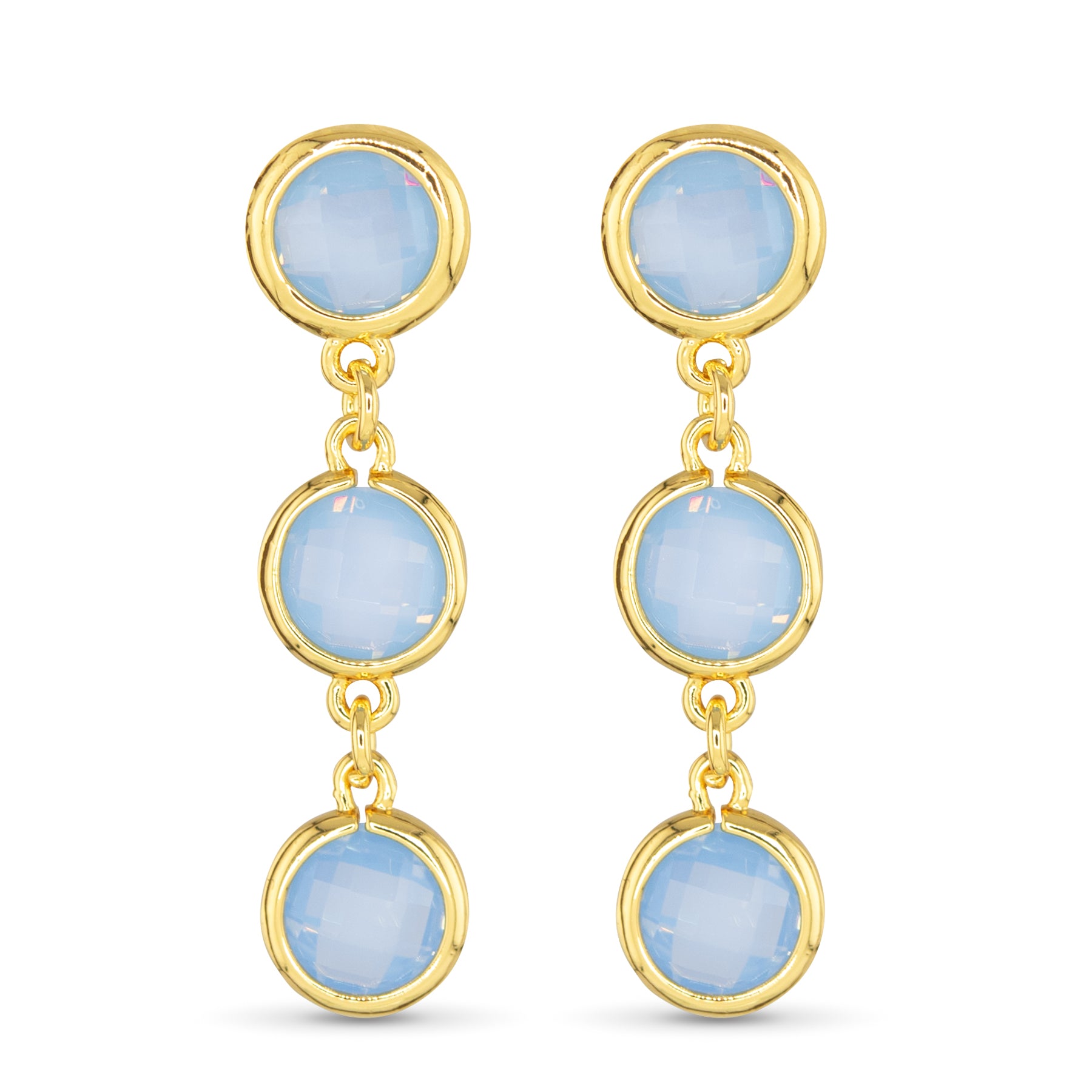 Gold earrings with blue gemstones on a white background. Available at Be Charmed