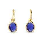 Gold earrings with blue gemstones on a white background. Available at Be Charmed