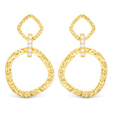 Gold hoop earrings with diamond-like stones on a white background. Available at Be Charmed