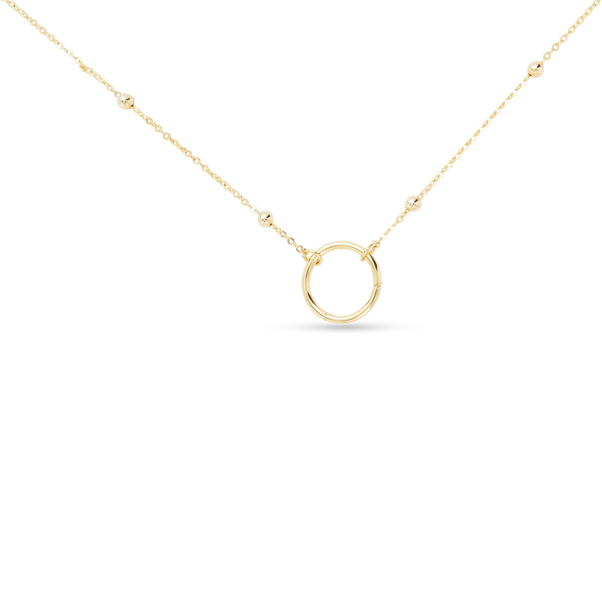 Gold charm necklace with a small round pendant on a white background. Available at Be Charmed