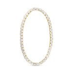 Gold tennis bracelet with clear gemstones on a white background. Available at Be Charmed