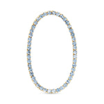 Tennis Bracelet with light blue gemstones and gold accents on a white background. Available at Be Charmed