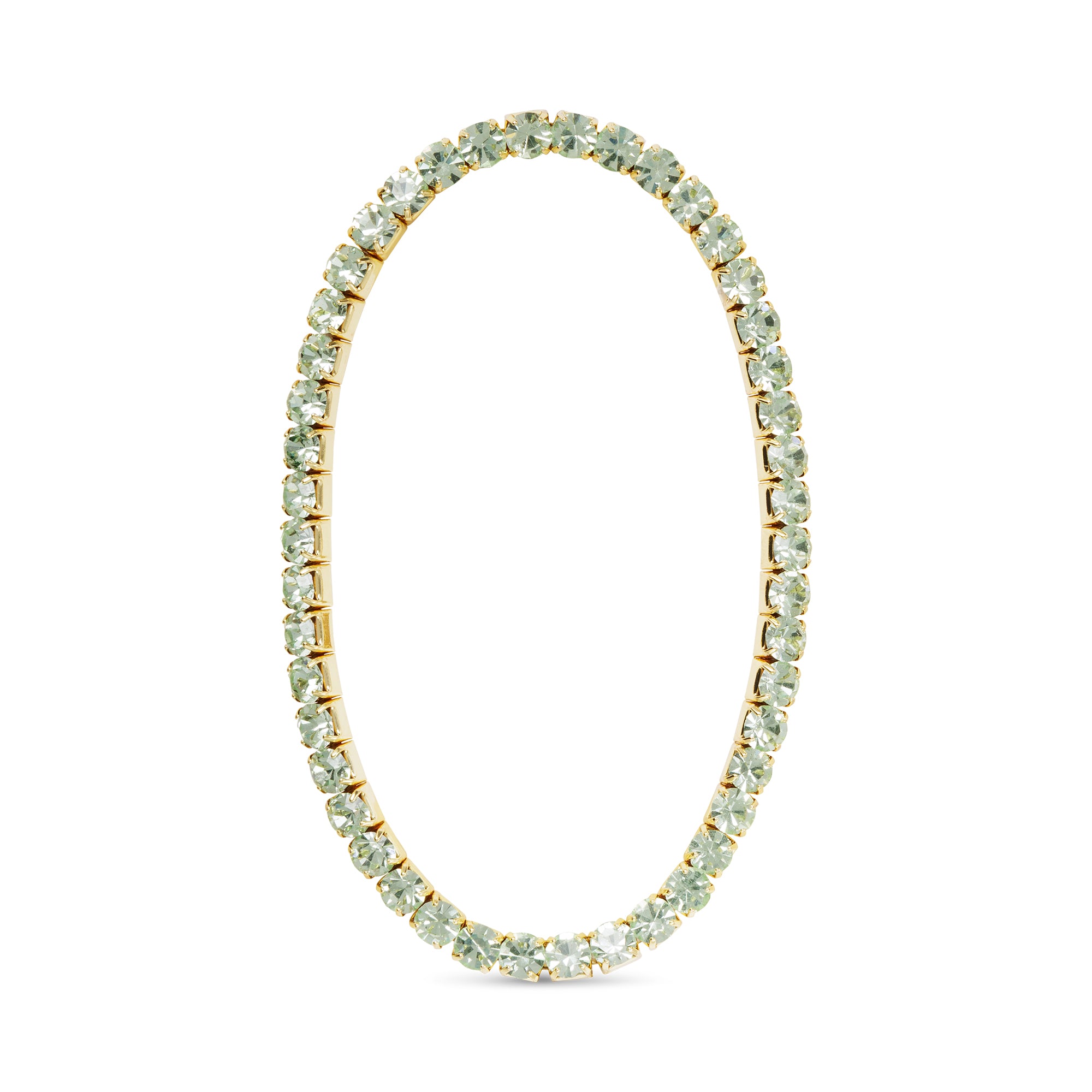 Gold tennis bracelet with light green gemstones on a white background. Available at Be Charmed
