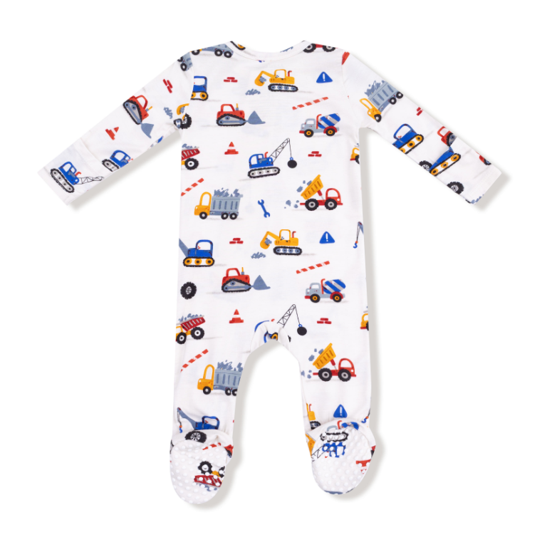 Baby onesie with construction vehicle pattern on a white background. Available at Be Charmed. 