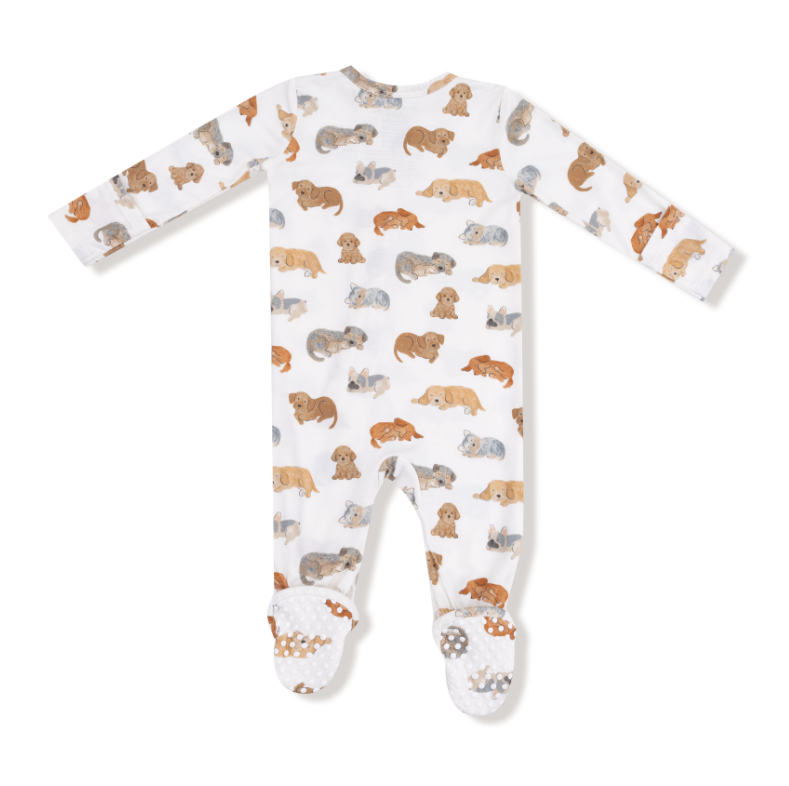 Baby onesie with dog pattern on a white background. Available at Be Charmed.