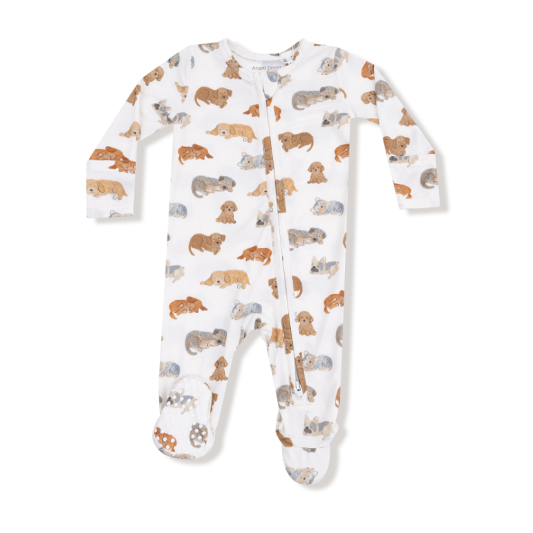 Baby onesie with dog pattern on a white background. Available at Be Charmed.