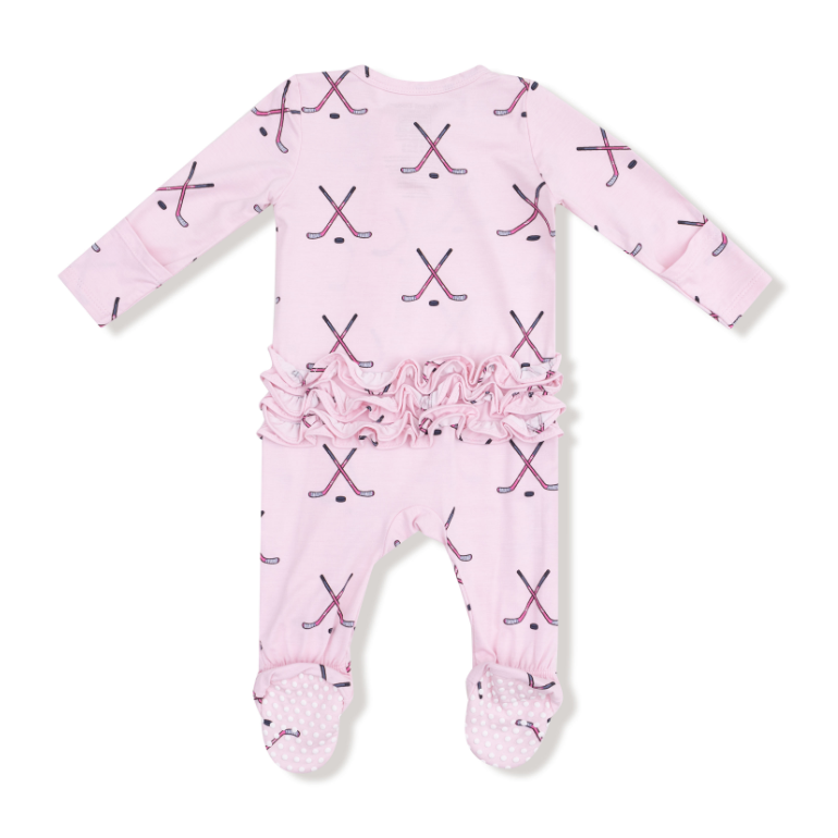 Pink baby onesie with hockey stick pattern on a white background. Available at Be Charmed. 