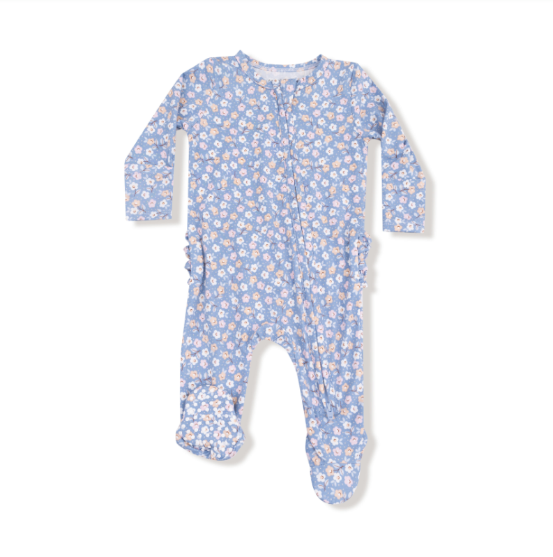 Baby onesie with floral pattern on a white background. Available at Be Charmed. 