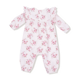 Floral-patterned baby onesie on a white background. Available at Be Charmed. 