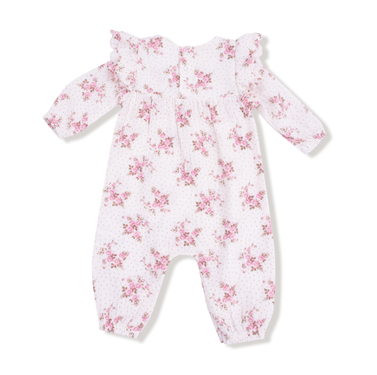 Floral-patterned baby onesie on a white background. Available at Be Charmed. 