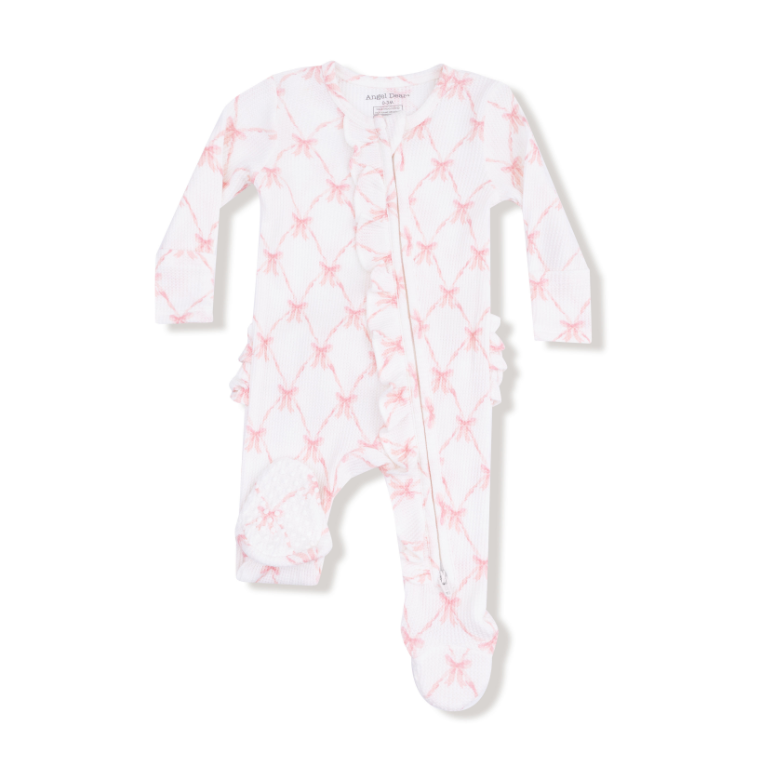 White baby onesie with pink star pattern on a white background. Available at Be Charmed