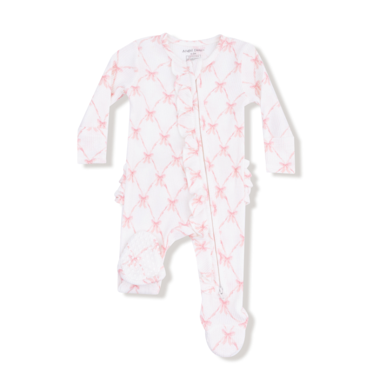White baby onesie with pink star pattern on a white background. Available at Be Charmed