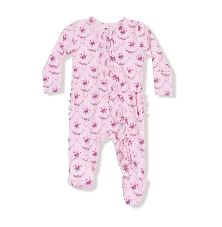 Pink baby onesie with floral pattern on a white background. Available at Be Charmed.