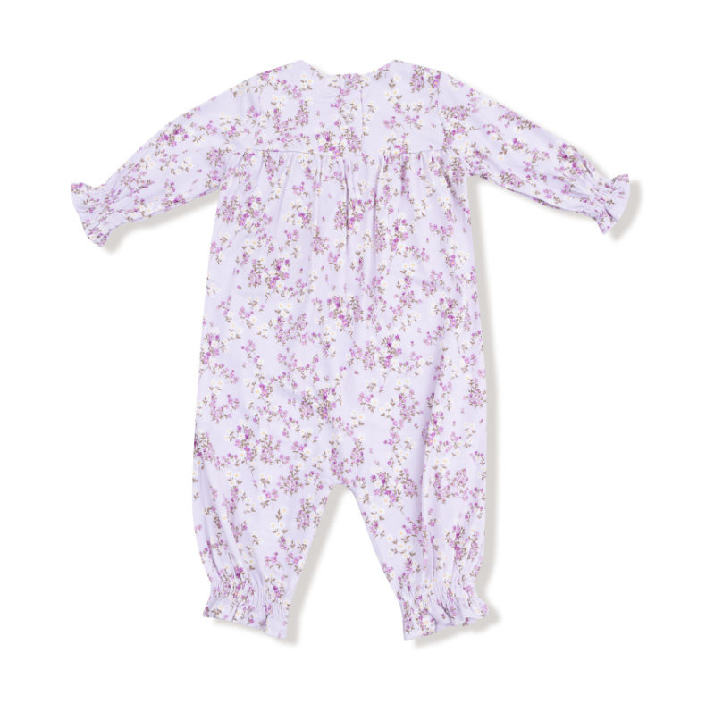 Floral-patterned baby romper on a white background. Available at Be Charmed. 