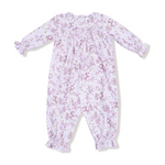 Floral patterned baby romper on a white background. Available at Be Charmed. 
